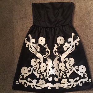 Black cocktail dress with white flower detail